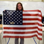 Skyline High teacher holds U.S. Flag in classroom