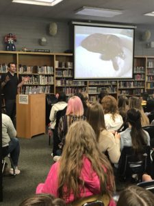 Author Brendan Reichs speaks to Evergreen Jr. High students in the media center