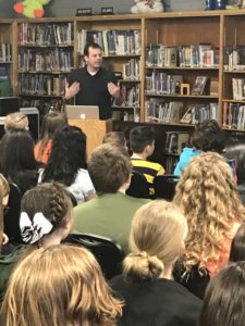 Author Brendan Reichs speaks to Evergreen Jr. High students in the media center