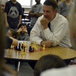 Photo of Superintendent Bates playing chess with a student