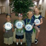 Photo of four students with Play Unplugged prizes