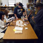 Photo of volunteers sorting Kearns Jr. High library books