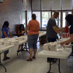 Photo of volunteers distributing supplies at Kearns Jr. High