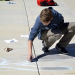 Photo of Wasatch Jr High student drawing with sidewalk chalk