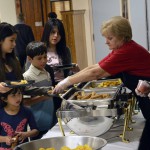 Photo of students receiving food during Latino Family Night