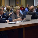 Photo of three administrators addressing board of education