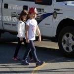 Photo of Eastwood Elementary students walking next to police vehicle