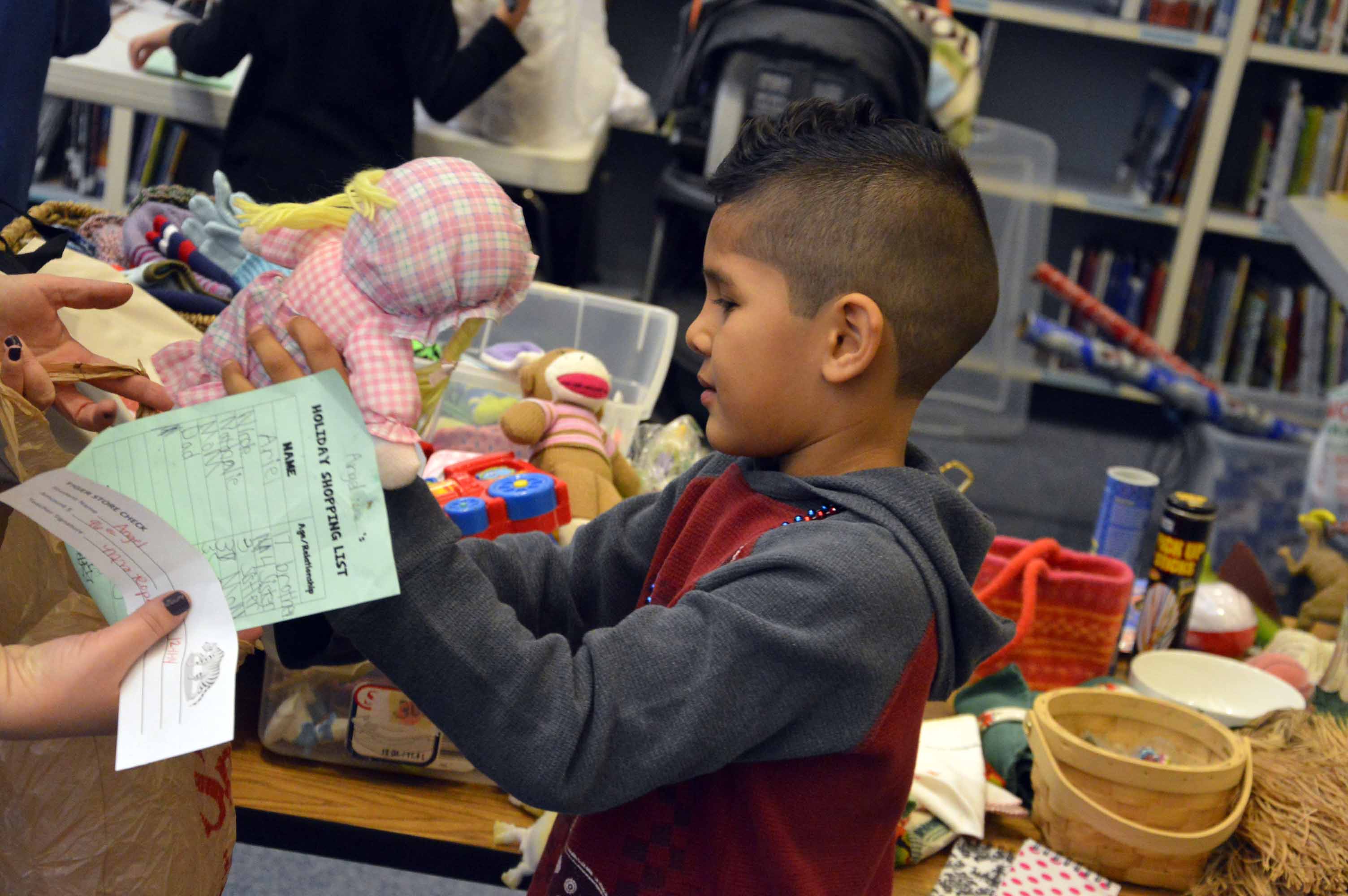 Students use their own high marks in school to buy gifts for family members