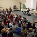Photo of superintendent reading book to Wright Elementary students