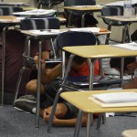 Photo of Hunter High students crouching under desks