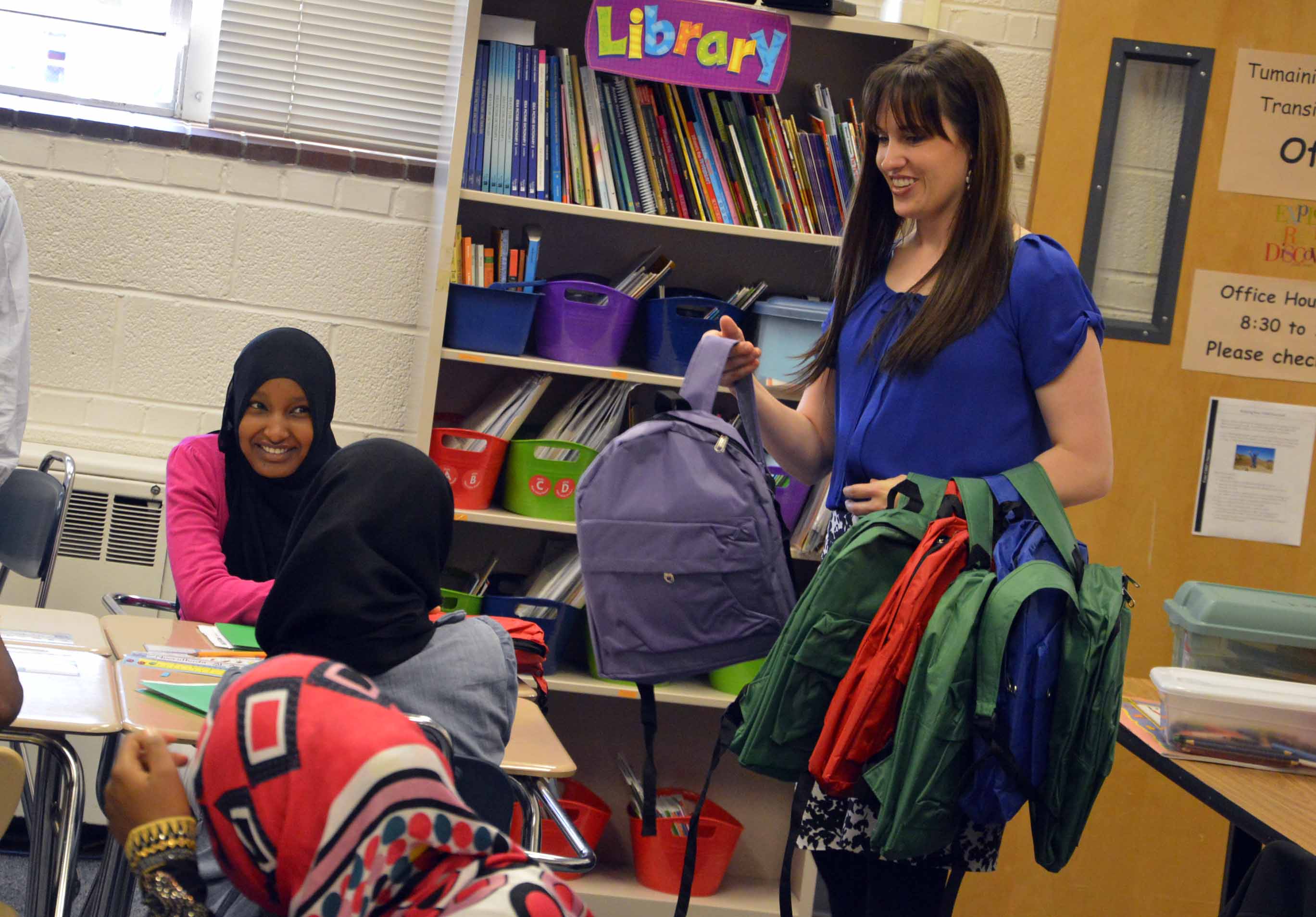 Refugee students receive backpacks before heading to home schools