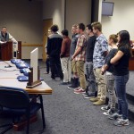 Photo of student athletes being recognized at board meeting