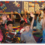Photo of Rolling Meadows students raising hands