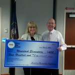 Photo of principal receiving attendance challenge check for school
