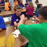 Photo of students building marshmallow tower