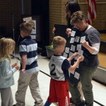 Photo of Bennion Elementary students taping papers to boards
