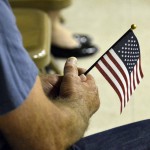 Photo of veteran holding American flag