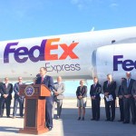 Photo of Utah Governor addressing media in front of airplane