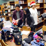 Photo of Kearns High students sorting donated winter clothes