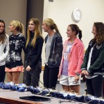 Photo of student athletes being recognized at board meeting