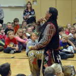 Photo of Native American teacher performing for Oakwood Elementary students