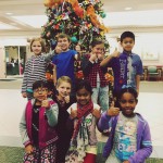 Photo of Wilson Elementary students posing with decorated tree