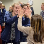Photo of student giving a high-five to board member