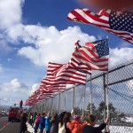Photo of students holding American flags on overpass