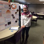 Photo of student posing in front of science project display