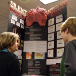 Photo of student explaining science project to judge