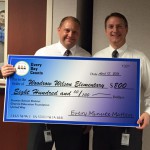 Photo of Wilson Elementary principal receiving large check