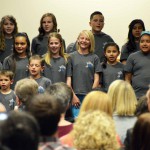 Photo of student choir singing during board meeting