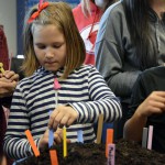 Photo of Wilson Elementary student planting seeds