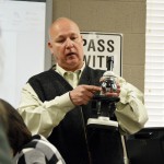 Photo of teacher explaining parts of microscope