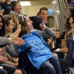 Teen in wheelchair waves to Hunter High students