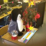 Stuffed penguin sits on Hunter Elementary desk