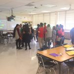 Kearns Jr. students gathered at the center of a classroom