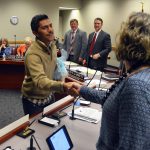 Taylorsville High student shaking hands with board members
