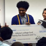Taylorsville High student holding giant check