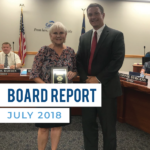 Legislator stands with Granite superintendent and text 'Board Report July 2018'