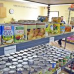 Food cans on shelves in food pantry