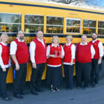 Granite School District HR team standing in front of bus