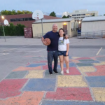 Father and daughter standing on Mill Creek Elementary map
