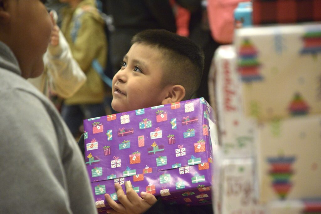 Image of boy receiving Christmas gift.